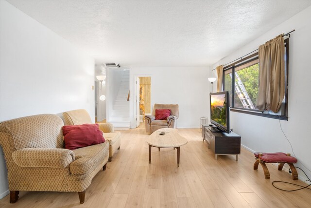 9200 Lagrima De Oro Rd NE, Albuquerque, NM 87111 - living area featuring light wood-type flooring and a textured ceiling