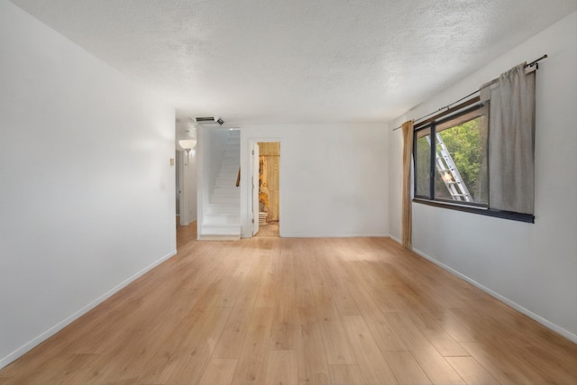 9200 Lagrima De Oro Rd NE, Albuquerque, NM 87111 - spare room featuring a textured ceiling and light wood finished floors