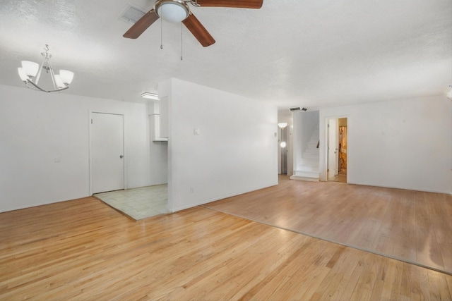9200 Lagrima De Oro Rd NE, Albuquerque, NM 87111 - empty room with wood finished floors, ceiling fan, and a chandelier