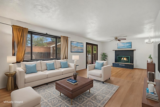 9200 Lagrima De Oro Rd NE, Albuquerque, NM 87111 - living room with wood finished floors, plenty of natural light, a ceiling fan, and a brick fireplace