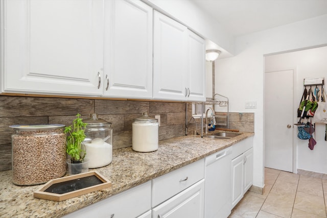 9200 Lagrima De Oro Rd NE, Albuquerque, NM 87111 - kitchen featuring white dishwasher, backsplash, white cabinetry, light stone counters, and light tile patterned floors