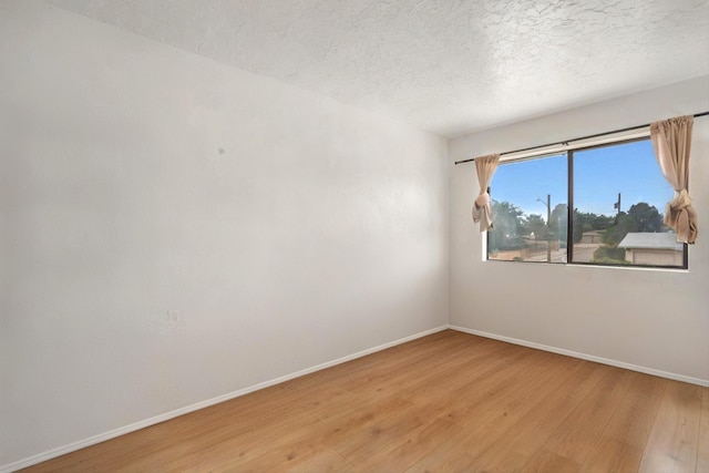 9200 Lagrima De Oro Rd NE, Albuquerque, NM 87111 - empty room featuring light wood-style flooring and a textured ceiling