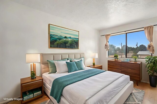 9200 Lagrima De Oro Rd NE, Albuquerque, NM 87111 - bedroom with wood finished floors and a textured ceiling