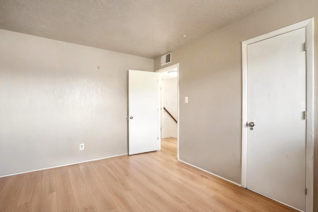 9200 Lagrima De Oro Rd NE, Albuquerque, NM 87111 - unfurnished bedroom with light wood finished floors and baseboards