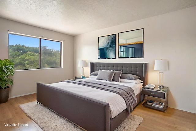 9200 Lagrima De Oro Rd NE, Albuquerque, NM 87111 - bedroom with light wood-type flooring and a textured ceiling