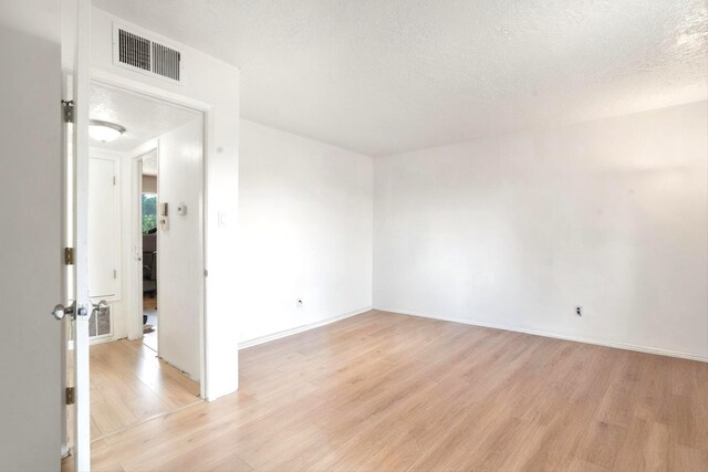 9200 Lagrima De Oro Rd NE, Albuquerque, NM 87111 - empty room with light wood-type flooring and a textured ceiling