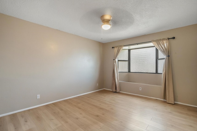 9200 Lagrima De Oro Rd NE, Albuquerque, NM 87111 - unfurnished room with light wood finished floors, a ceiling fan, and a textured ceiling