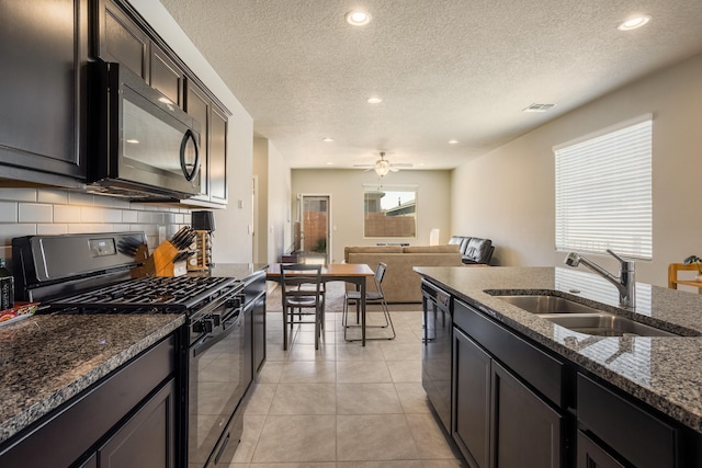4880 Blackburn Rd, Rio Rancho, NM 87144 - kitchen with black appliances, tasteful backsplash, dark stone countertops, recessed lighting, and a ceiling fan