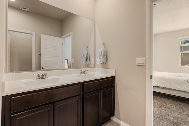 4880 Blackburn Rd, Rio Rancho, NM 87144 - ensuite bathroom featuring double vanity and baseboards