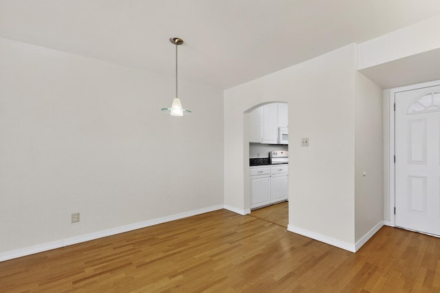 1821 Dartmouth Dr NE Unit 104, Albuquerque, NM 87106 - empty room with light wood finished floors and arched walkways