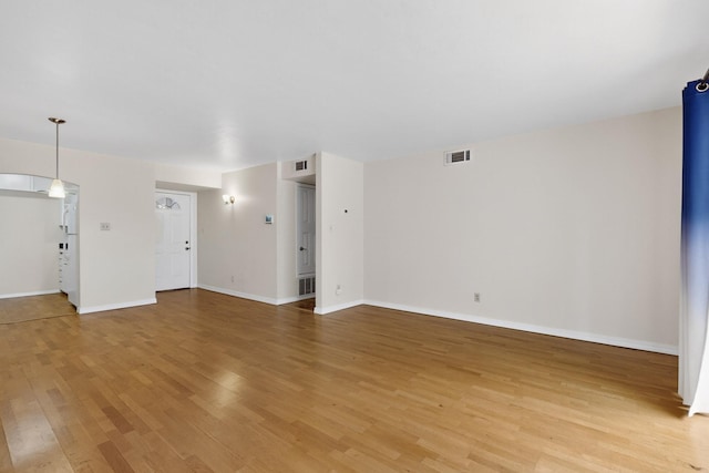 1821 Dartmouth Dr NE Unit 104, Albuquerque, NM 87106 - unfurnished living room with light wood-style floors and baseboards