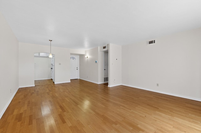1821 Dartmouth Dr NE Unit 104, Albuquerque, NM 87106 - unfurnished living room with light wood finished floors and baseboards