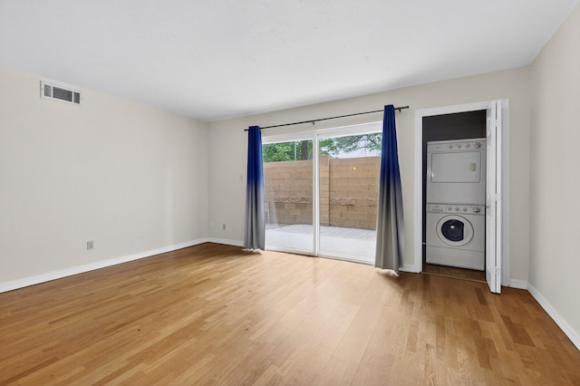 1821 Dartmouth Dr NE Unit 104, Albuquerque, NM 87106 - unfurnished room with estacked washer and dryer and light wood finished floors