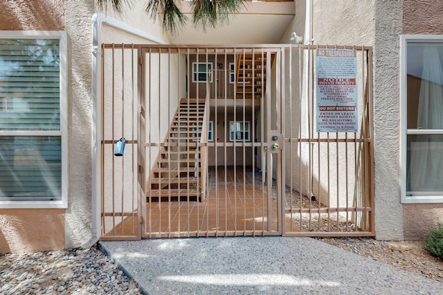 1821 Dartmouth Dr NE Unit 104, Albuquerque, NM 87106 - view of exterior entry featuring a gate and stucco siding