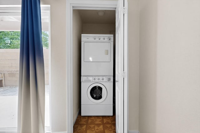 1821 Dartmouth Dr NE Unit 104, Albuquerque, NM 87106 - washroom with stacked washing machine and dryer and baseboards