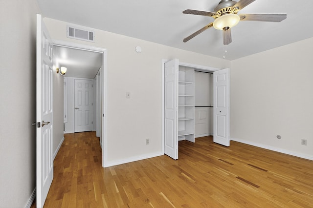 1821 Dartmouth Dr NE Unit 104, Albuquerque, NM 87106 - unfurnished bedroom with light wood finished floors, a closet, and ceiling fan