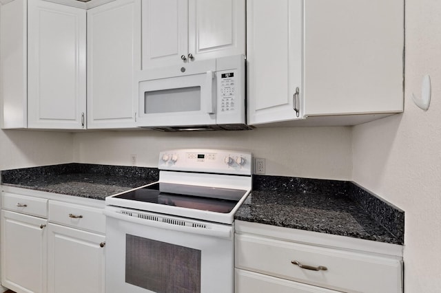 1821 Dartmouth Dr NE Unit 104, Albuquerque, NM 87106 - kitchen with white appliances, white cabinetry, and dark stone counters