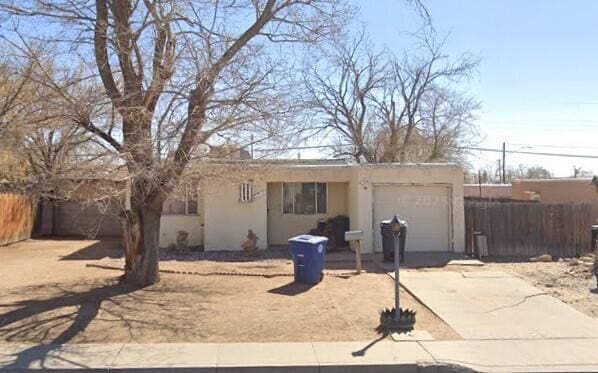 10804 Constitution Ave NE, Albuquerque, NM 87112 - view of front facade with an attached garage, driveway, and stucco siding