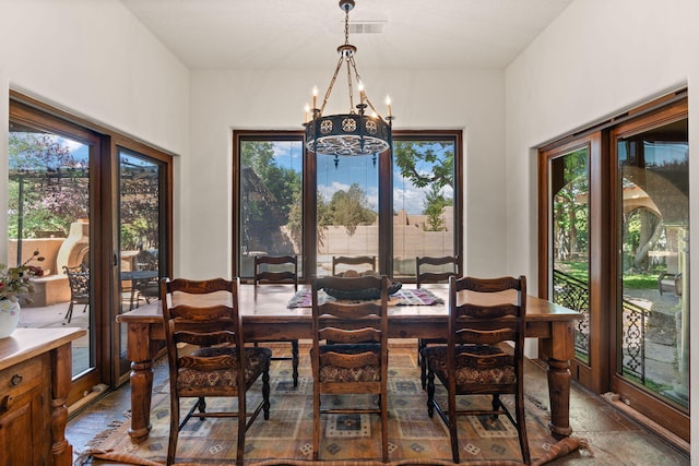 746 Chamisal Rd NW, Los Ranchos, NM 87107 - dining space with a chandelier and stone finish floors