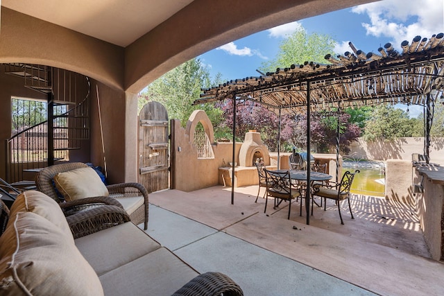 746 Chamisal Rd NW, Los Ranchos, NM 87107 - view of patio featuring a gate, outdoor dining space, and an outdoor hangout area