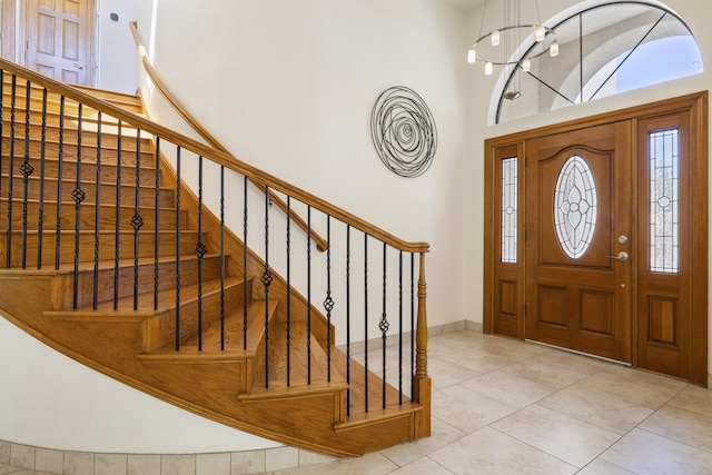 8712 Greenarbor Rd NE, Albuquerque, NM 87122 - foyer entrance with plenty of natural light, stairs, a towering ceiling, and tile patterned floors