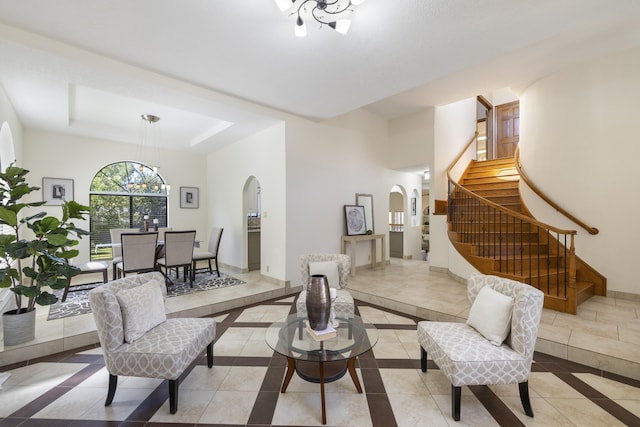 8712 Greenarbor Rd NE, Albuquerque, NM 87122 - dining room featuring arched walkways, inlaid floor details, stairway, a raised ceiling, and a chandelier