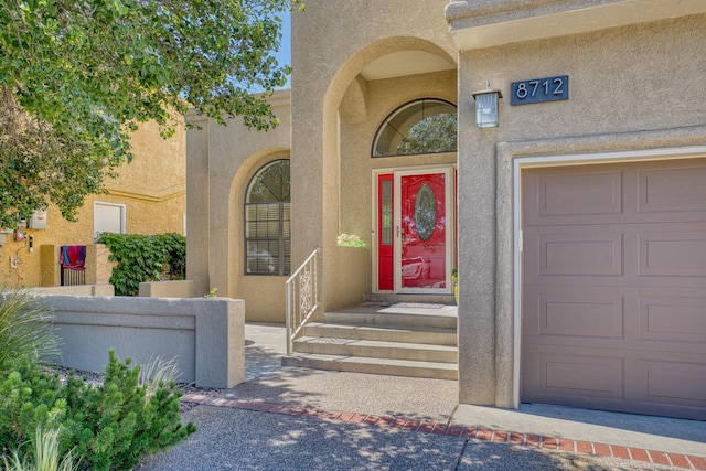 8712 Greenarbor Rd NE, Albuquerque, NM 87122 - doorway to property with stucco siding and a garage