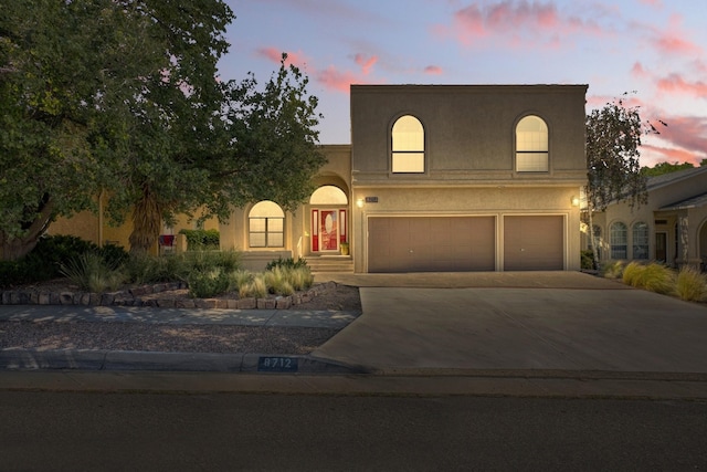 8712 Greenarbor Rd NE, Albuquerque, NM 87122 - view of front of property featuring a garage, driveway, and stucco siding