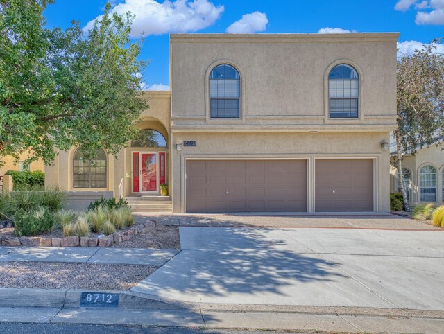 8712 Greenarbor Rd NE, Albuquerque, NM 87122 - view of front of house featuring a garage, stucco siding, and driveway