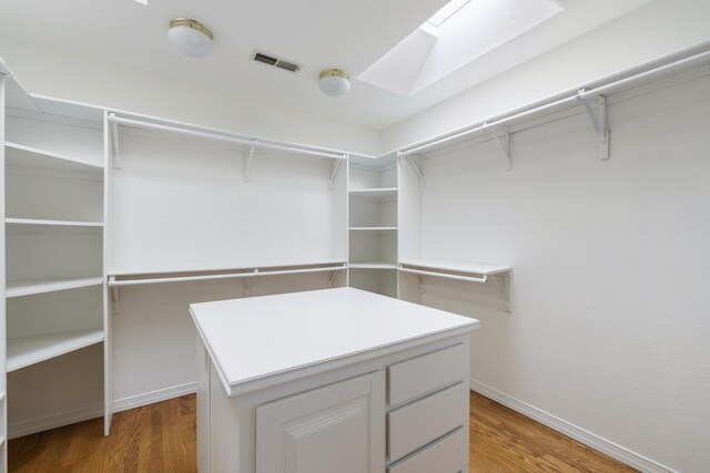 8712 Greenarbor Rd NE, Albuquerque, NM 87122 - spacious closet featuring a skylight and light wood finished floors