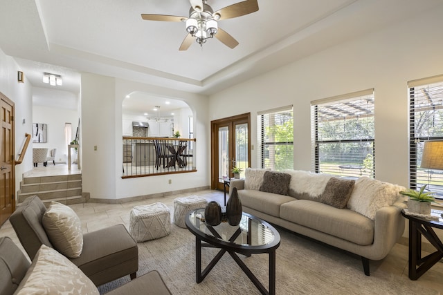 8712 Greenarbor Rd NE, Albuquerque, NM 87122 - living room with a tray ceiling, ceiling fan, and arched walkways