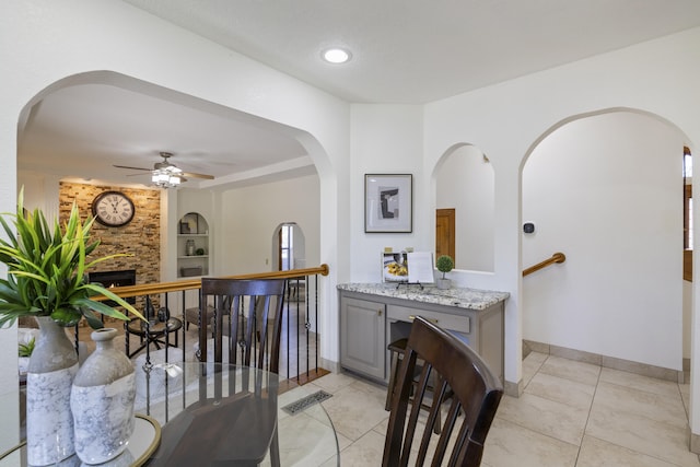 8712 Greenarbor Rd NE, Albuquerque, NM 87122 - hallway with arched walkways, light tile patterned floors, and built in shelves