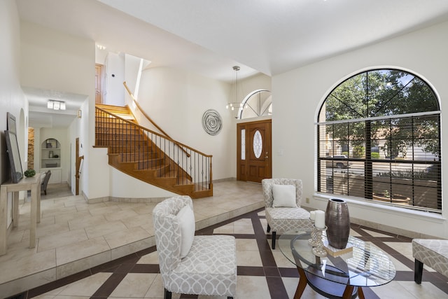 8712 Greenarbor Rd NE, Albuquerque, NM 87122 - tiled entrance foyer featuring inlaid floor details, stairs, and a towering ceiling