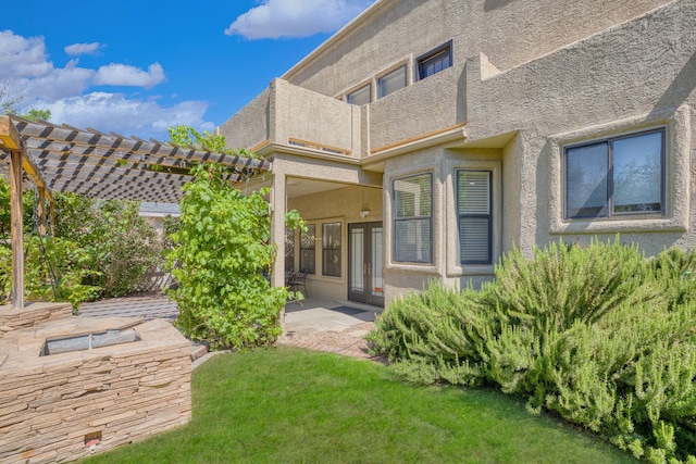 8712 Greenarbor Rd NE, Albuquerque, NM 87122 - rear view of property with stucco siding, a pergola, a balcony, a yard, and french doors