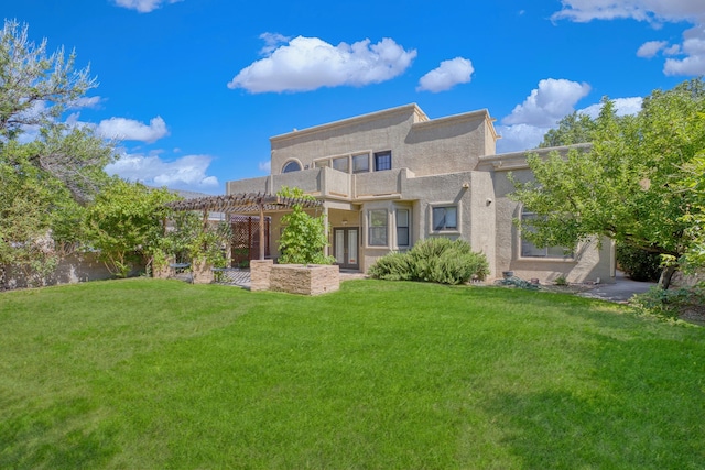 8712 Greenarbor Rd NE, Albuquerque, NM 87122 - back of house featuring a balcony, a lawn, a pergola, and stucco siding