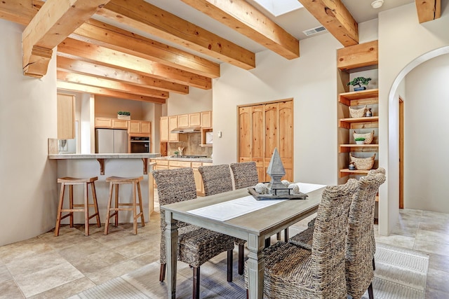 120 Espinosa Rd, Corrales, NM 87048 - dining space featuring beam ceiling, arched walkways, and a skylight
