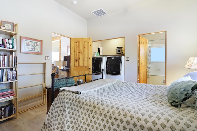 120 Espinosa Rd, Corrales, NM 87048 - bedroom featuring independent washer and dryer and wood finished floors
