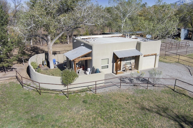 120 Espinosa Rd, Corrales, NM 87048 - rear view of house featuring stucco siding, a garage, and driveway