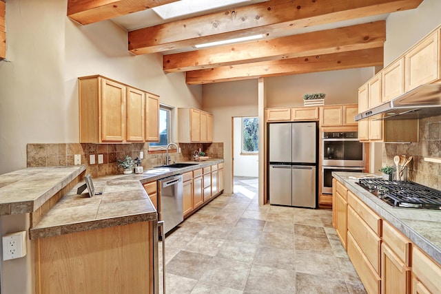 120 Espinosa Rd, Corrales, NM 87048 - kitchen with stainless steel appliances, light brown cabinetry, beam ceiling, backsplash, and under cabinet range hood
