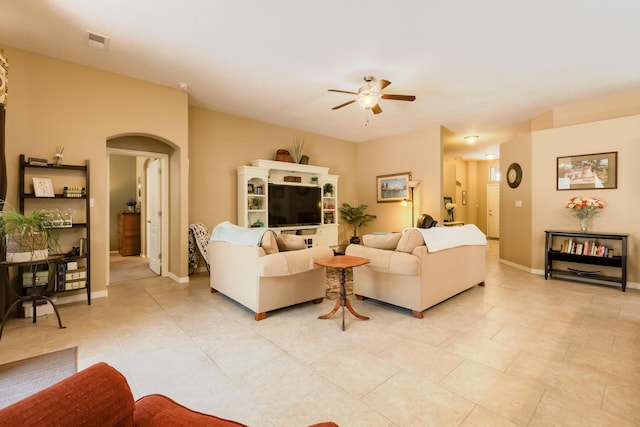 4601 Mi Cordelia Dr NW, Albuquerque, NM 87120 - living area with arched walkways, a ceiling fan, and light tile patterned floors