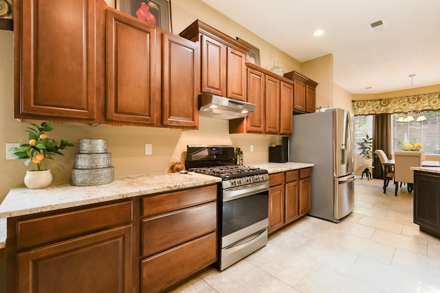 4601 Mi Cordelia Dr NW, Albuquerque, NM 87120 - kitchen featuring appliances with stainless steel finishes, under cabinet range hood, decorative light fixtures, light stone countertops, and light tile patterned flooring