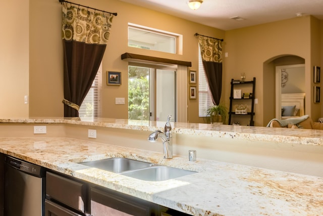 4601 Mi Cordelia Dr NW, Albuquerque, NM 87120 - kitchen featuring dishwasher, light stone countertops, and arched walkways