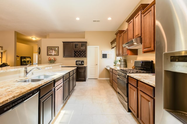 4601 Mi Cordelia Dr NW, Albuquerque, NM 87120 - kitchen with appliances with stainless steel finishes, under cabinet range hood, light stone countertops, light tile patterned flooring, and recessed lighting