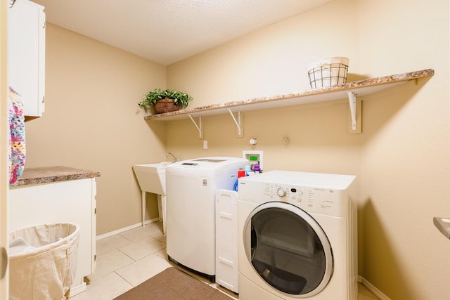 4601 Mi Cordelia Dr NW, Albuquerque, NM 87120 - laundry area with washing machine and dryer, light tile patterned flooring, and cabinet space
