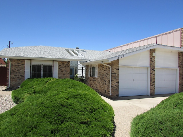 3109 Dallas St NE, Albuquerque, NM 87110 - single story home featuring brick siding, a garage, concrete driveway, and roof with shingles
