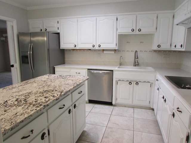 3109 Dallas St NE, Albuquerque, NM 87110 - kitchen with stainless steel appliances, ornamental molding, white cabinetry, and backsplash