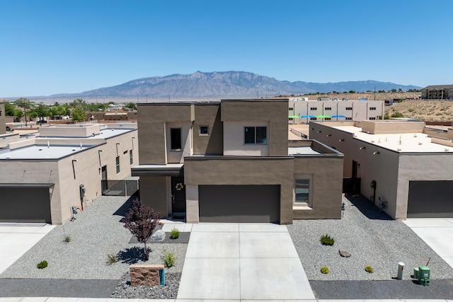 4381 Lauren Loop NE, Rio Rancho, NM 87124 - view of front of property featuring a mountain view, concrete driveway, stucco siding, and an attached garage