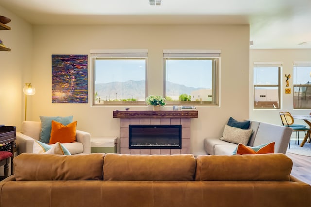 4381 Lauren Loop NE, Rio Rancho, NM 87124 - living room featuring healthy amount of natural light, wood finished floors, and a tile fireplace