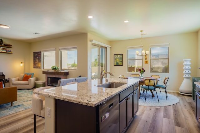 4381 Lauren Loop NE, Rio Rancho, NM 87124 - kitchen featuring healthy amount of natural light, stainless steel dishwasher, light wood-style floors, a breakfast bar, and recessed lighting