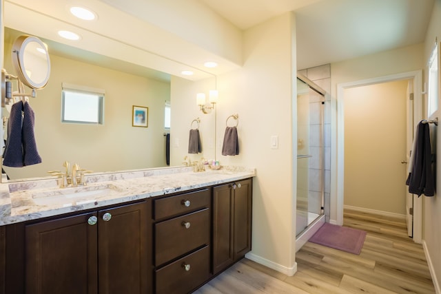 4381 Lauren Loop NE, Rio Rancho, NM 87124 - bathroom with a stall shower, double vanity, wood finished floors, and recessed lighting
